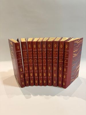 six red books lined up in a row on a white surface