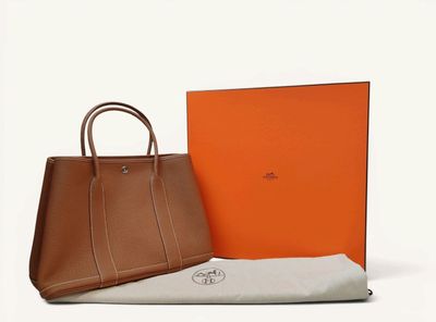 a brown bag sitting next to an orange box on a white surface