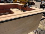 a boat that is sitting on the ground in front of a building