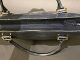 a handbag hanging on a wall with a handle