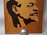 a bust of a man on a table next to a picture of a man