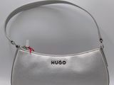 the purse is silver and has a red bow on the handle