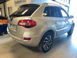 the rear end of a silver suv parked in a garage