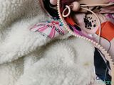 a doll that is holding a pair of scissors in her hand