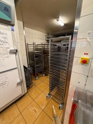 a picture of a commercial kitchen with many racks of food