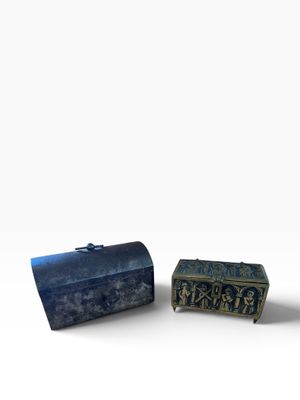 two small metal boxes sitting next to each other on top of a white surface