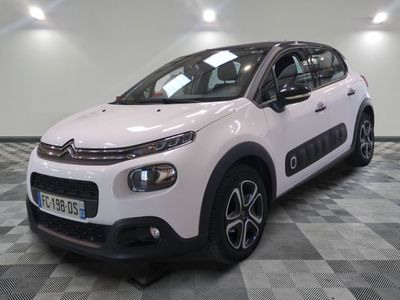the white citrole is parked on a checkered tile floor
