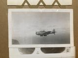 a black and white photo of a plane flying in the sky
