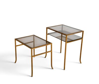a pair of brass side tables with glass tops