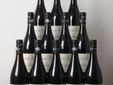 many bottles of wine sitting on a wooden table
