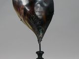 a black vase with a black and white design on it