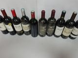 several bottles of wine are lined up in a row on a table