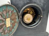 a clock that is sitting inside of a metal box