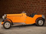 an orange vintage car parked in front of a brick wall