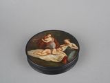 a small black box with a painting of a woman laying on a bed