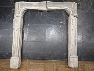 a marble fireplace surround in a room with a black wall