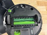 a black and green robot that is sitting on a table