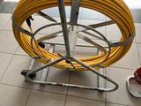 a yellow hose on a metal cart on the floor