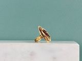 a close up of a gold ring on a marble block