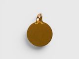 a gold plated pendant with a round shape on a white background