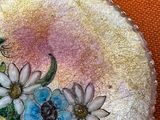 a picture of a broochee with flowers and a bee on it