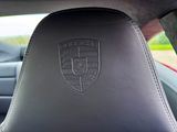 a black leather seat in a car with a logo on it