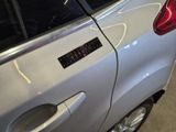 a silver car with a sticker on the side of it