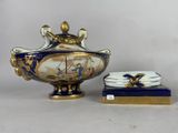 a blue and gold vase and a box on a table