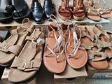 many pairs of shoes that are on a table