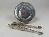 a picture of a silver plate with spoons and a picture of a man in a mirror