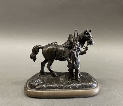 bronze statue of a man on a horse holding a staff