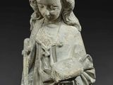 a statue of a woman holding a book in her hands