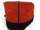 a red and black hat with a bow on top of it