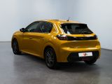the rear end of a yellow car in a white room