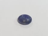 a close up of a blue stone on a white surface