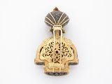 an image of a gold and black broochle with a bird on it