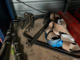 a pile of tools sitting on the floor in a garage