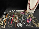 many different types of necklaces and bracelets on the table