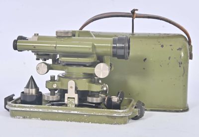 a small green machine with a metal case on it