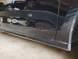 a picture of a car that has been dented and is parked in a garage