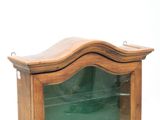a wooden display case with a glass door on it