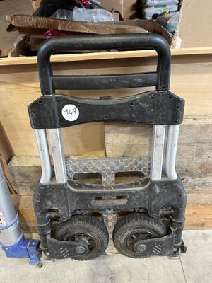 a dolly that is sitting on the floor next to a box