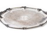 a silver tray with a circular design on it