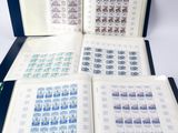an open book with stamps on it sitting on top of a table
