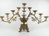 an ornate brass candelab with five arms and five lights
