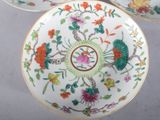 two plates with floral designs on them are sitting on a table