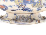 a white bowl with a blue and orange design on it