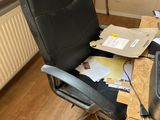 a desk with a chair and a computer on it
