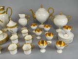 a lot of white and gold items that are on the table