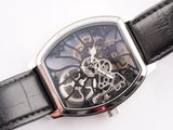 a close up of a watch on a white surface
